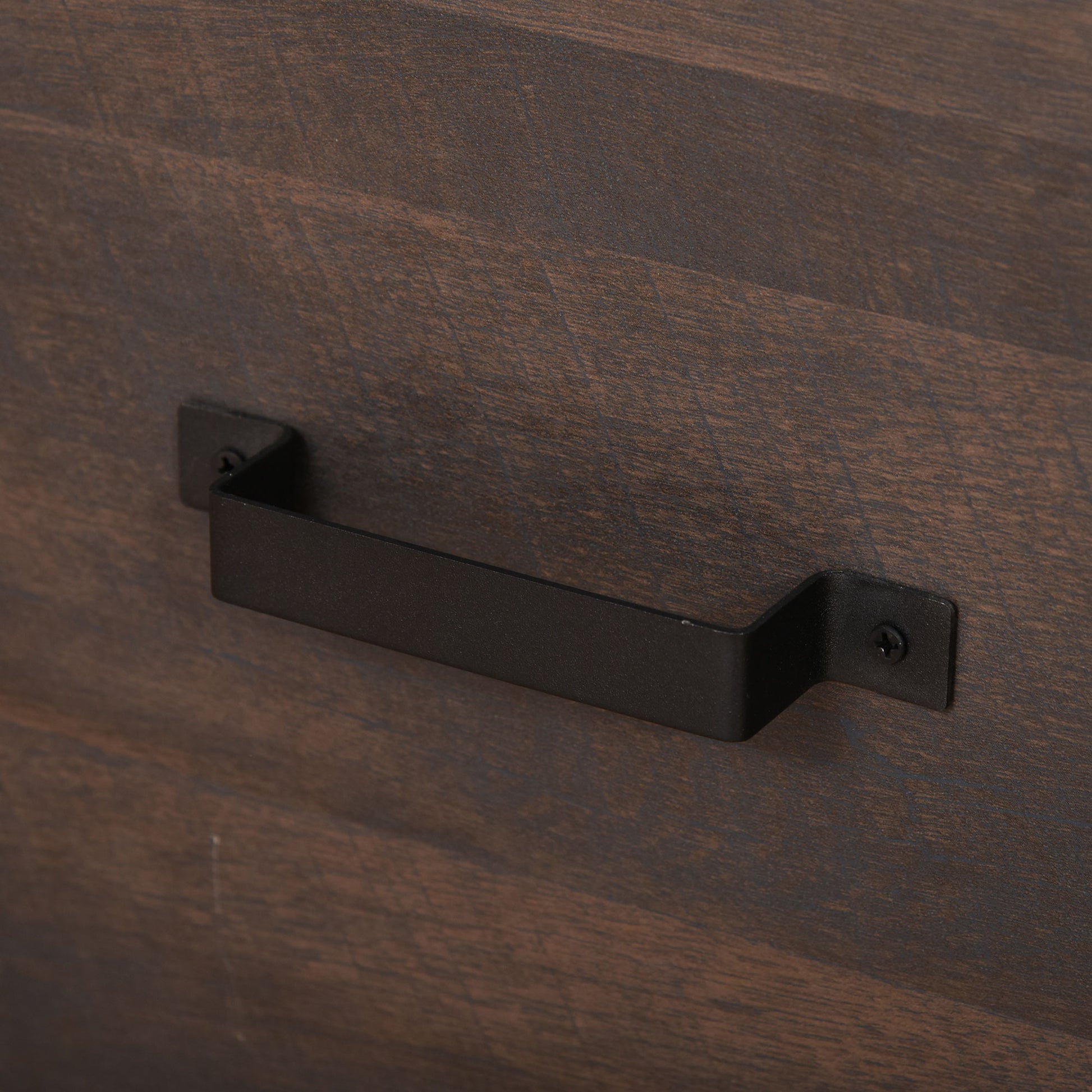 Dark wood dresser drawer with black bar pull handle closeup