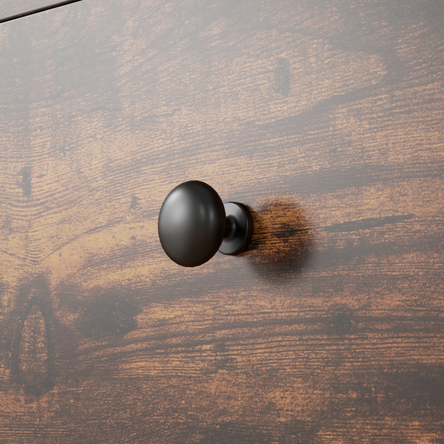 Matte black round knob drawer pull on a distressed wood dresser front