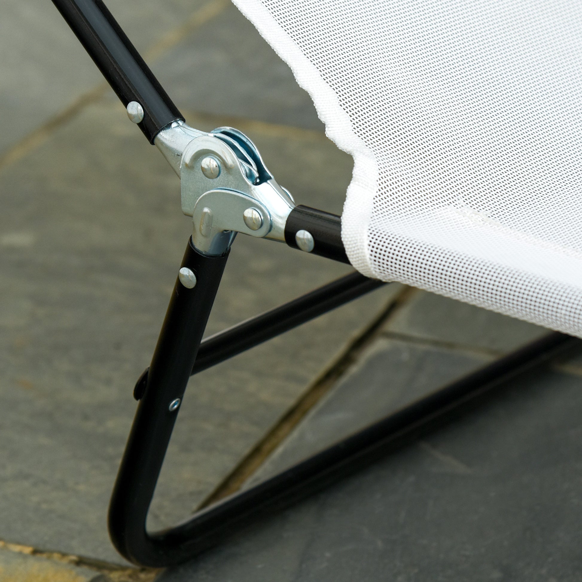 Closeup of a black metal frame and white mesh fabric on a portable camping chair