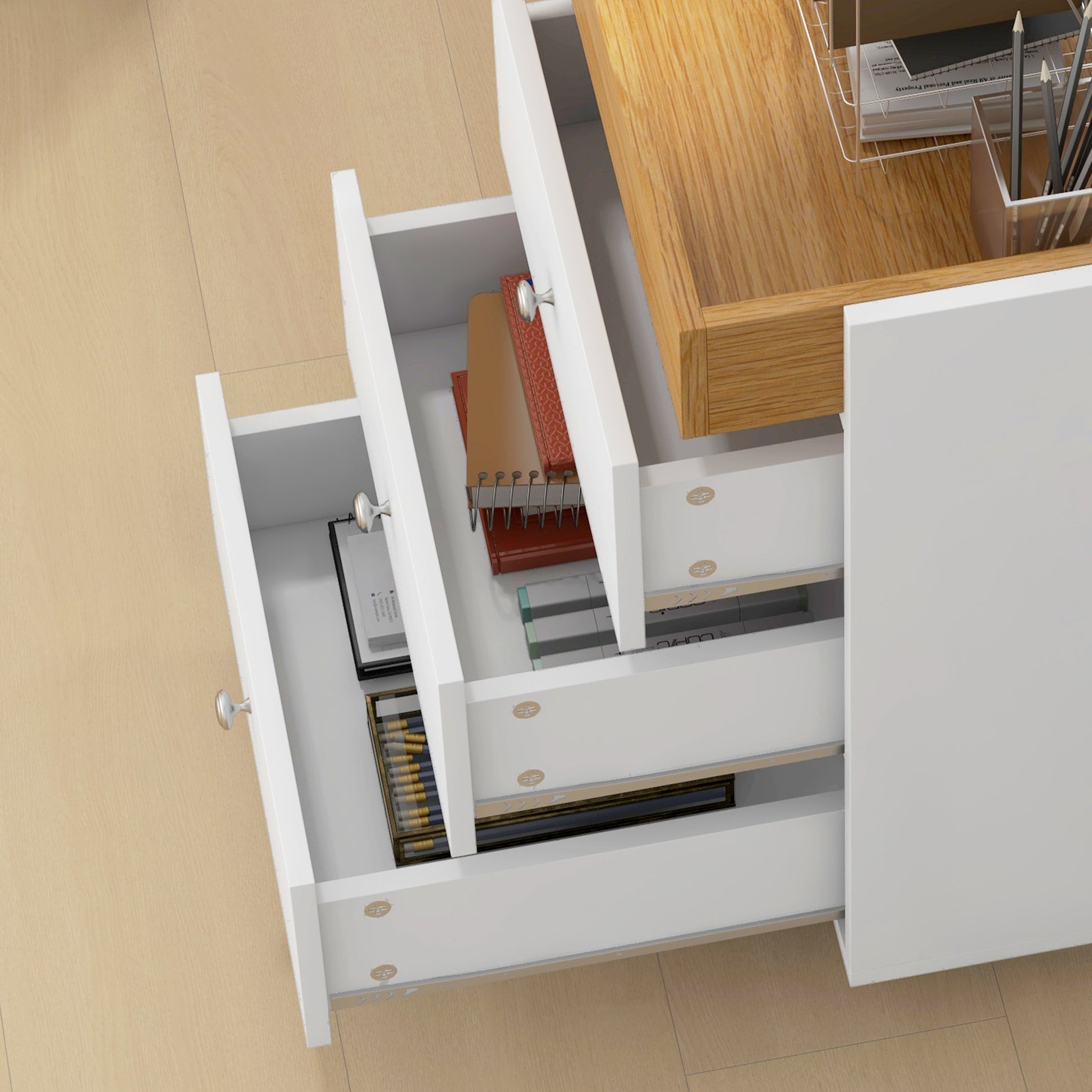 White modern desk drawers open showing office supplies and books