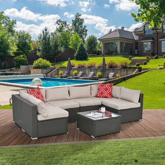 Dark grey wicker sectional sofa with beige cushions and red patterned pillows for outdoor patio