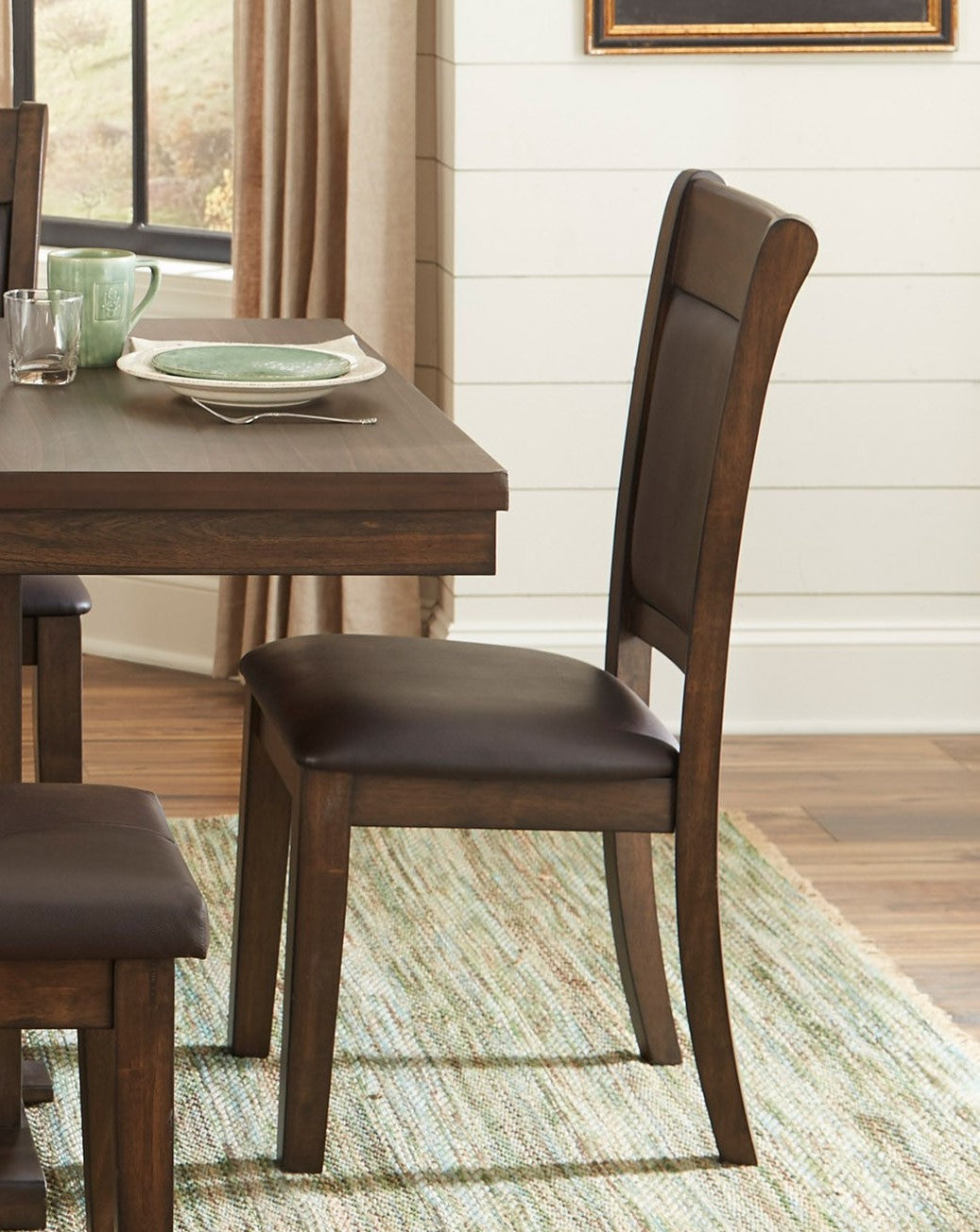 Dark brown wooden dining chair with upholstered seat and backrest