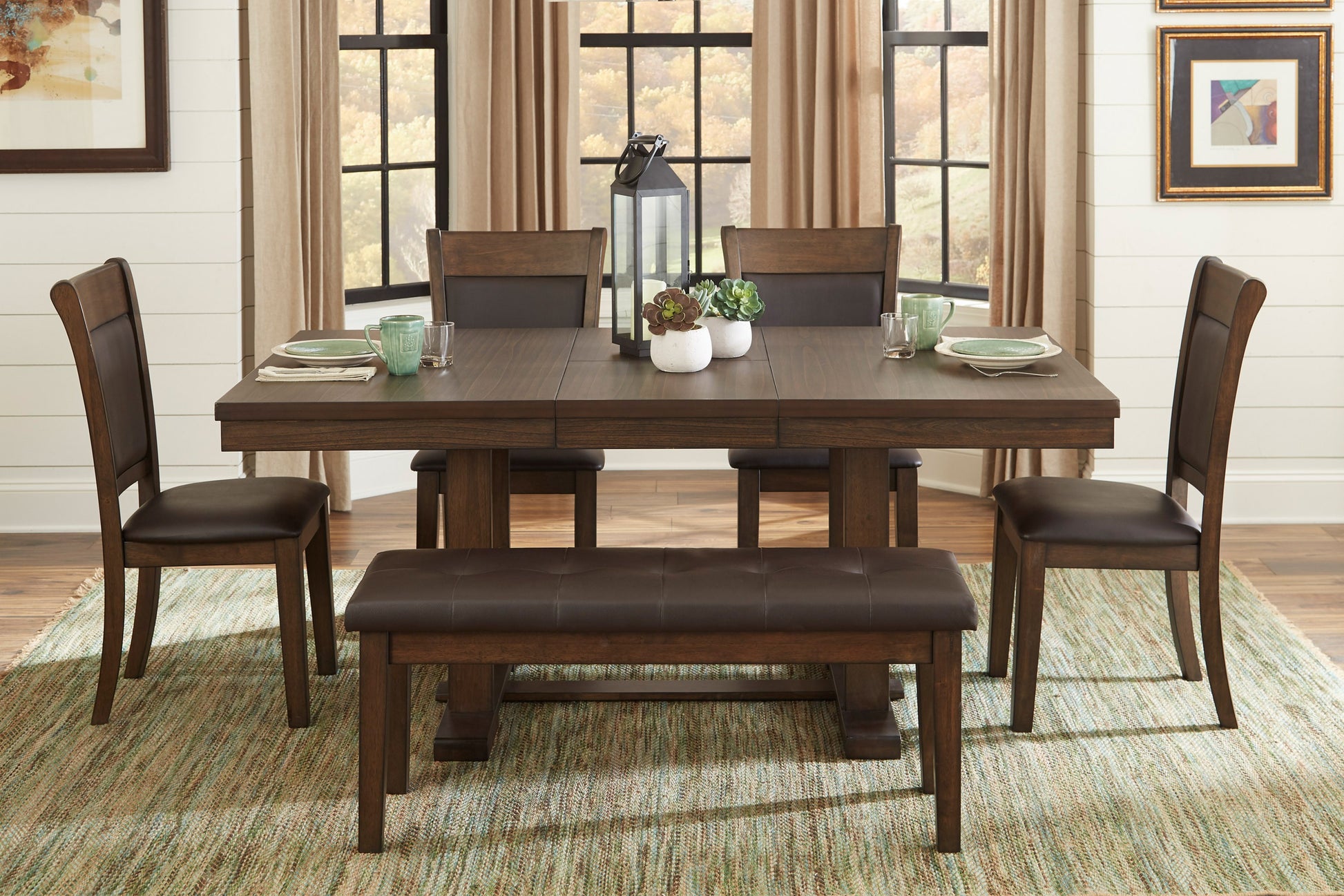 Dark wood dining table with faux leather chairs and bench