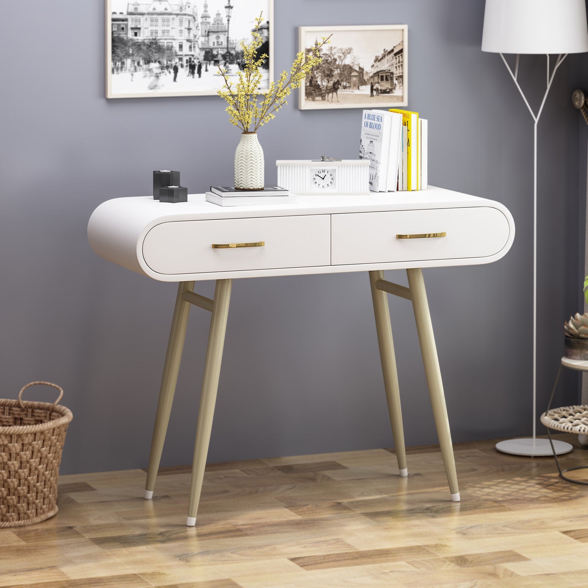 Curved white console table with brass hardware and tapered legs featuring two drawers for storage
