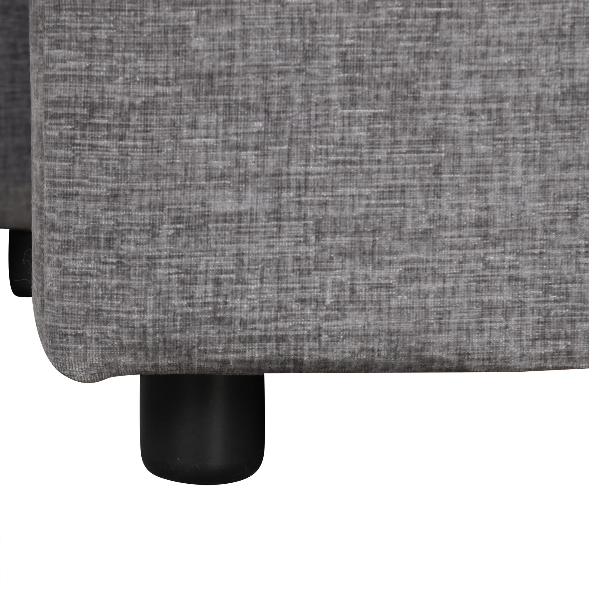 Closeup of textured grey fabric sofa upholstery with black cylindrical legs