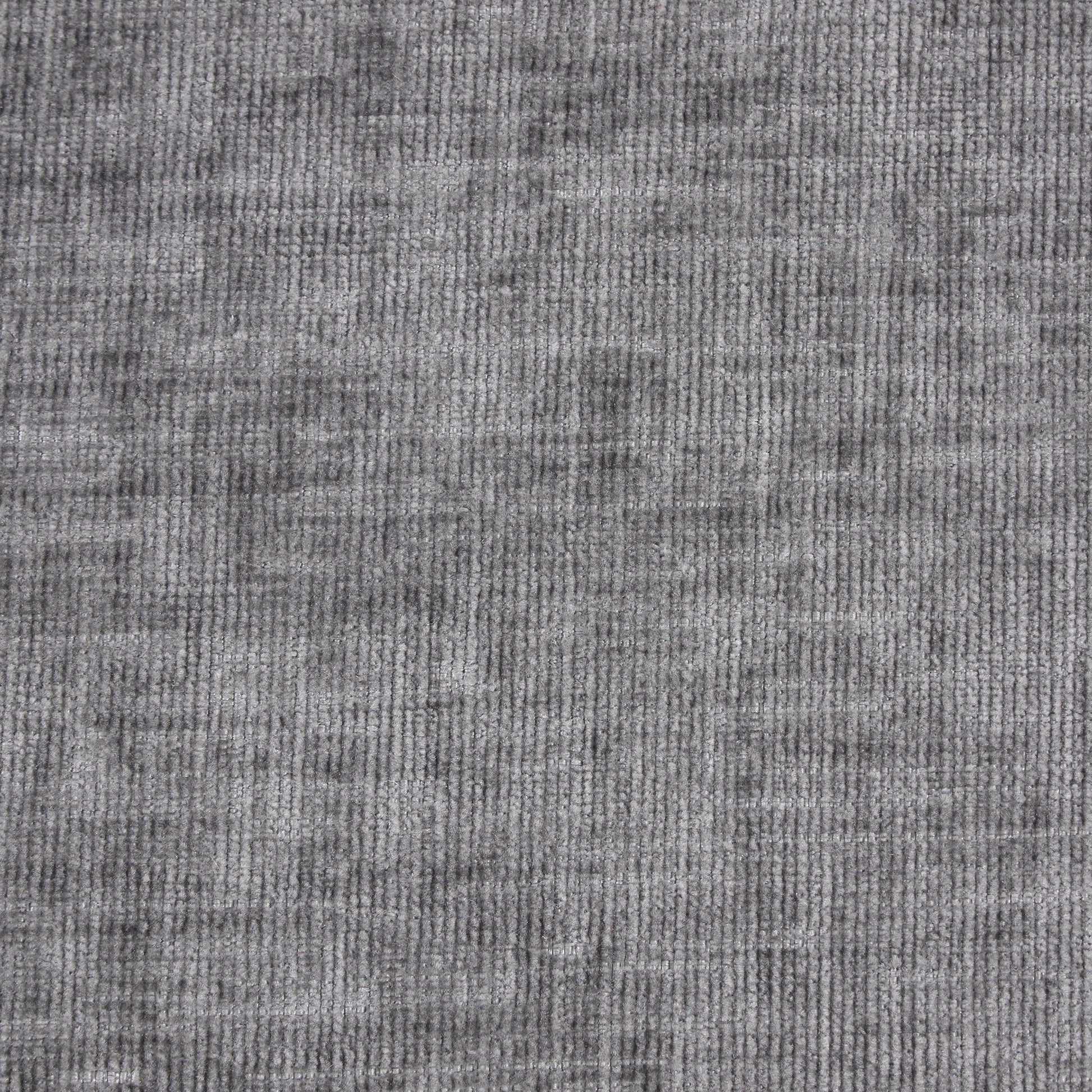 Closeup of textured gray velvet fabric with subtle vertical ribbing for upholstery