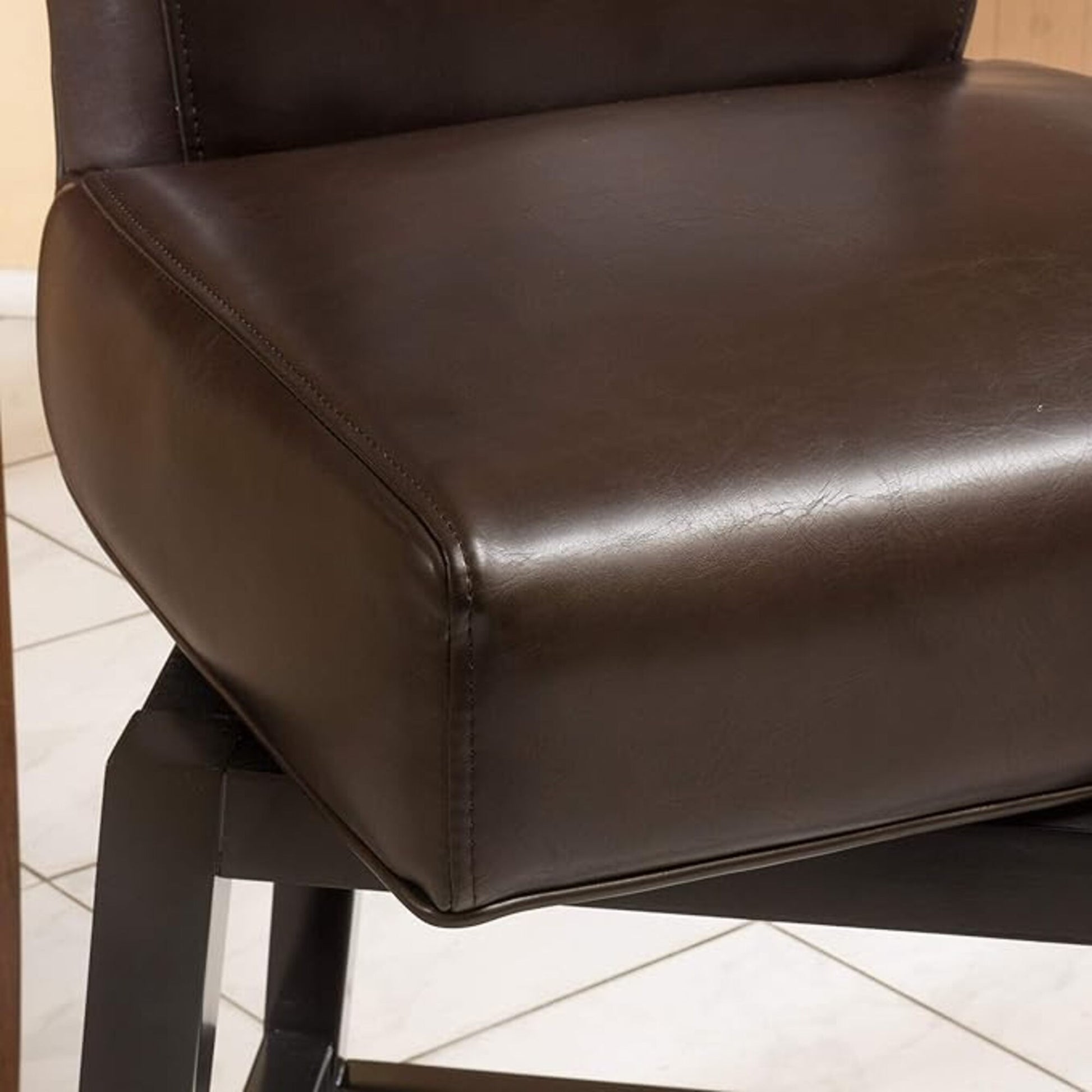 Brown faux leather bar stool seat with visible stitching