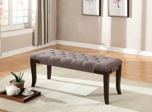 Tufted grey fabric bench with dark wood legs
