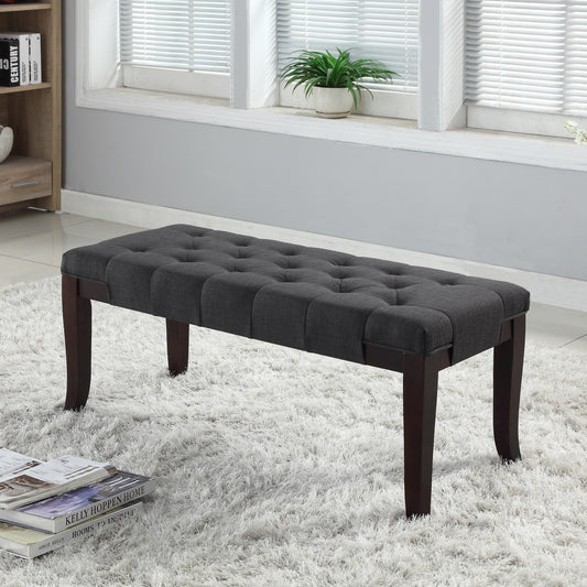 Dark gray tufted upholstered bench with dark wood legs