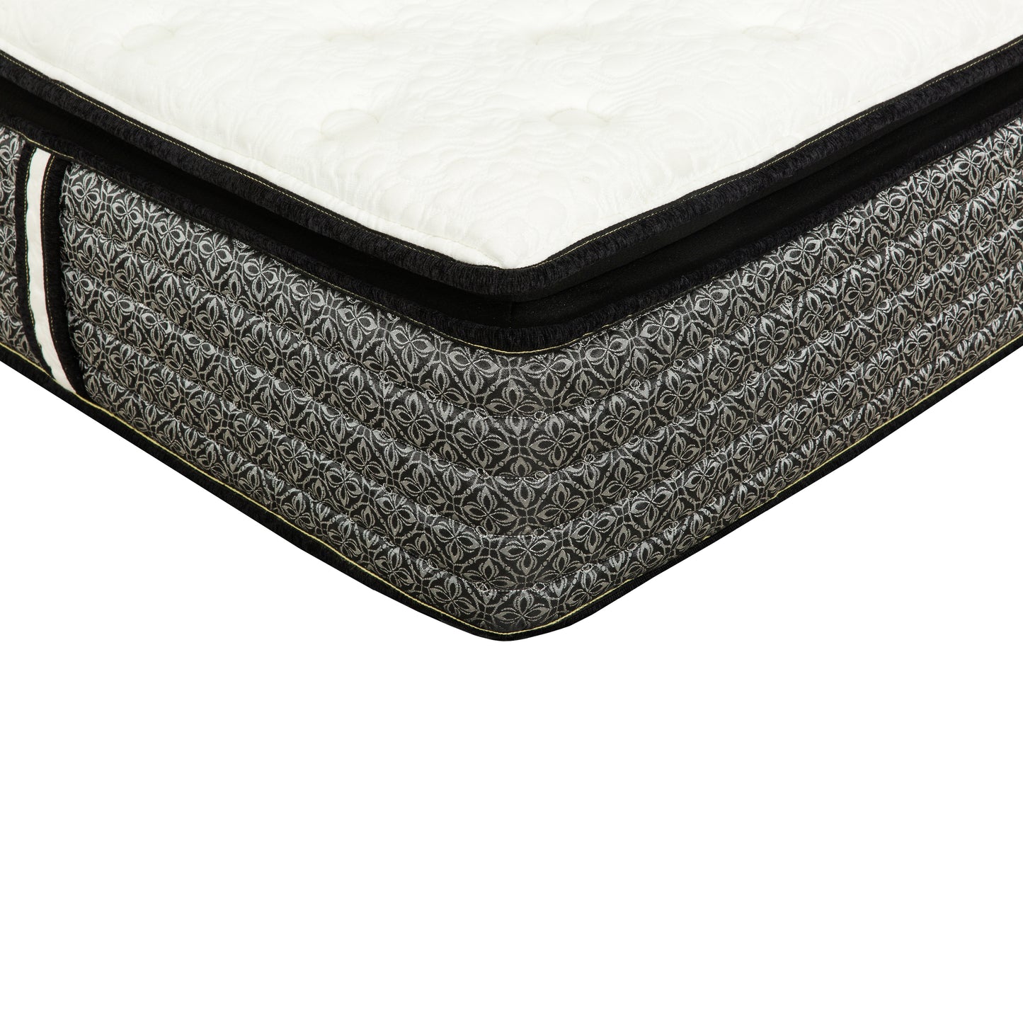 Closeup of a queen size mattress with a white quilted top and black sides featuring a silver floral pattern