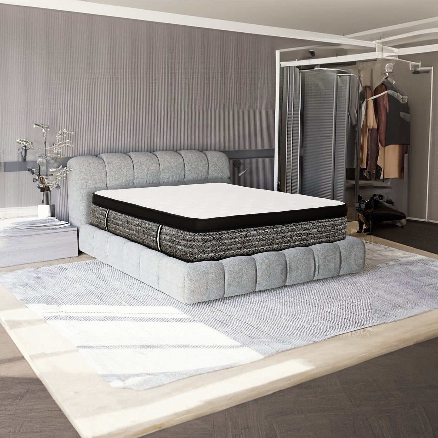 Plush gray upholstered bed frame with a white and black patterned hybrid mattress