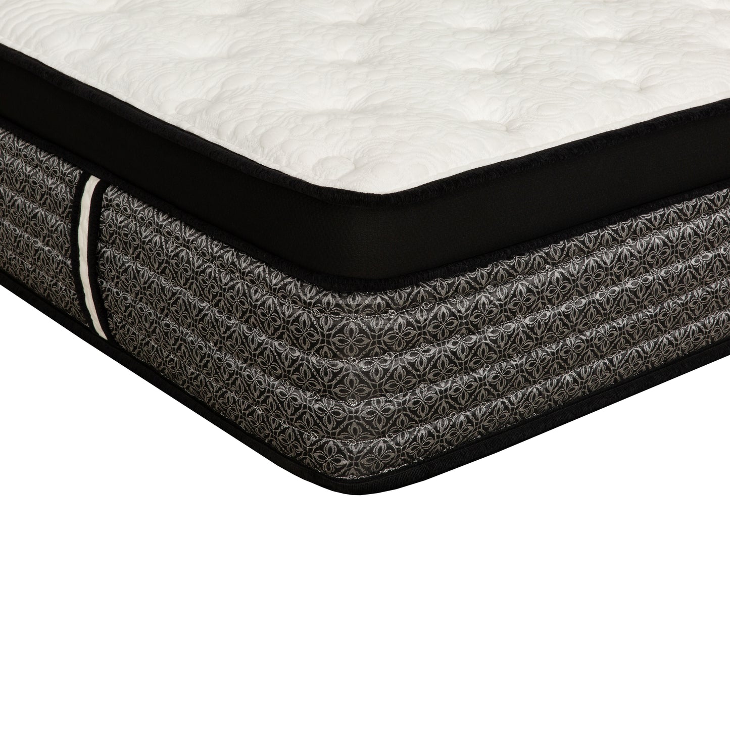 Closeup of a tufted white mattress with a black border and grey patterned side
