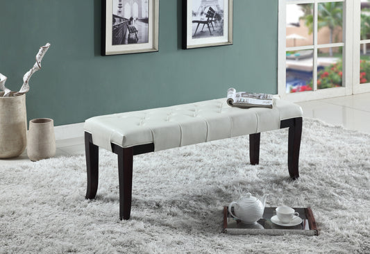 White tufted faux leather bench with dark wood legs