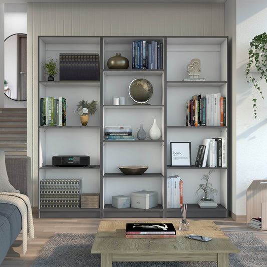 Modern grey and white bookshelf filled with books decorative objects and a globe