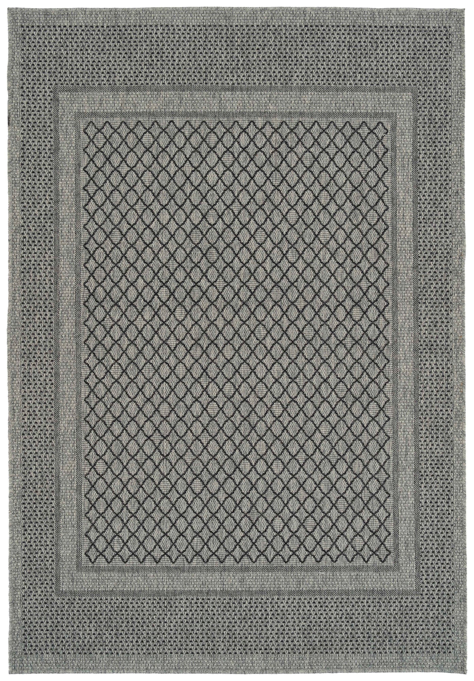Gray area rug with a central diamond pattern and geometric border