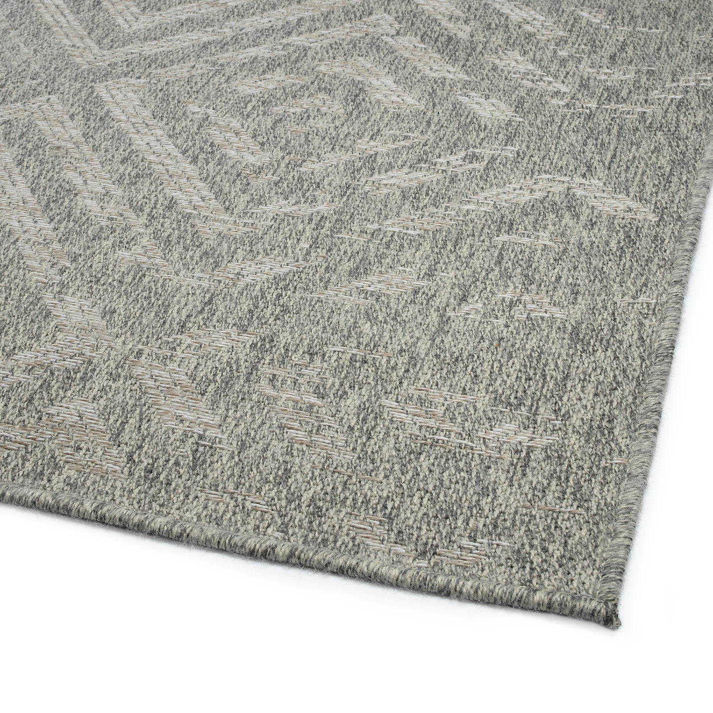 Closeup of a grey geometric pattern outdoor rug with textured weave perfect for patios