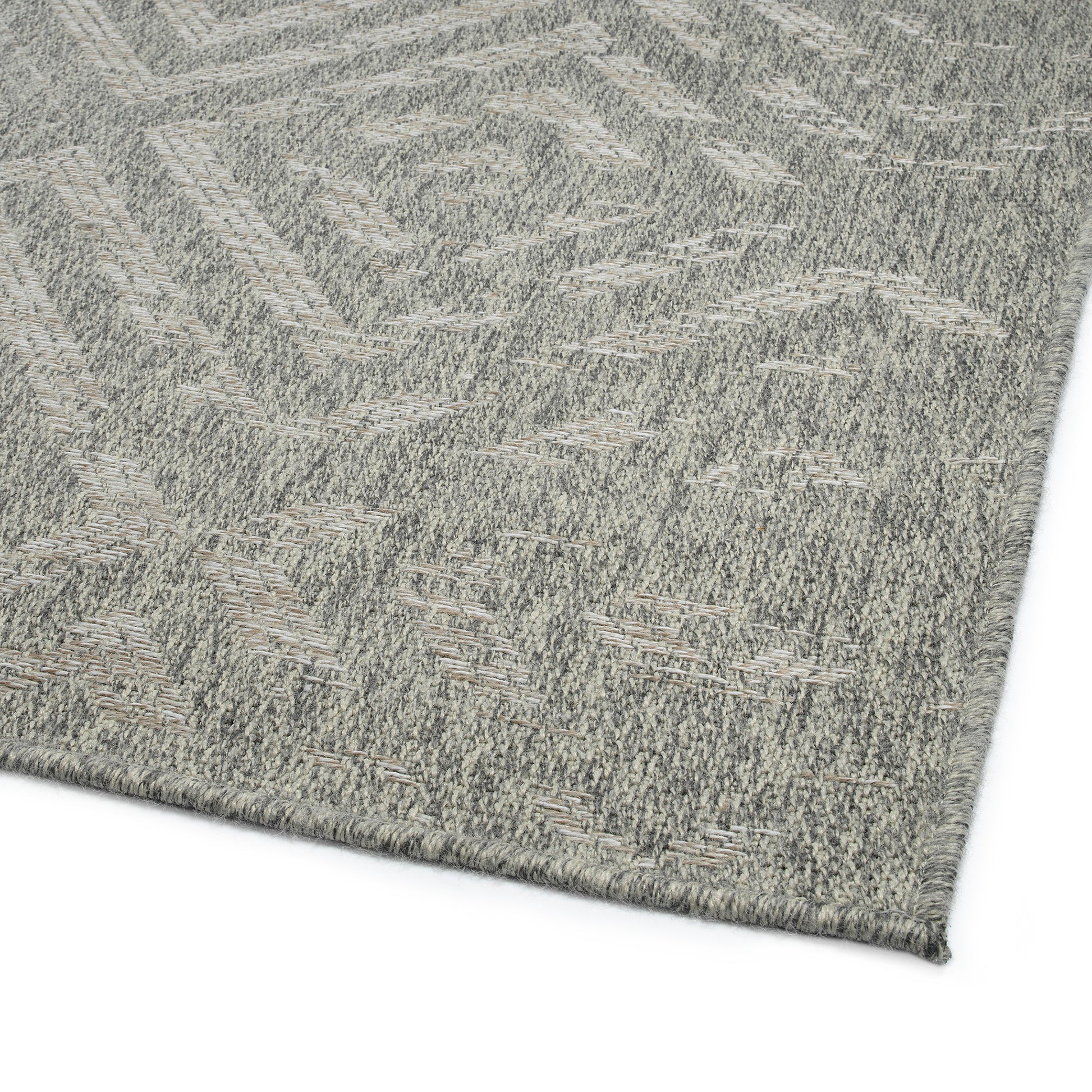 Closeup of a grey geometric pattern outdoor rug with textured weave perfect for patios