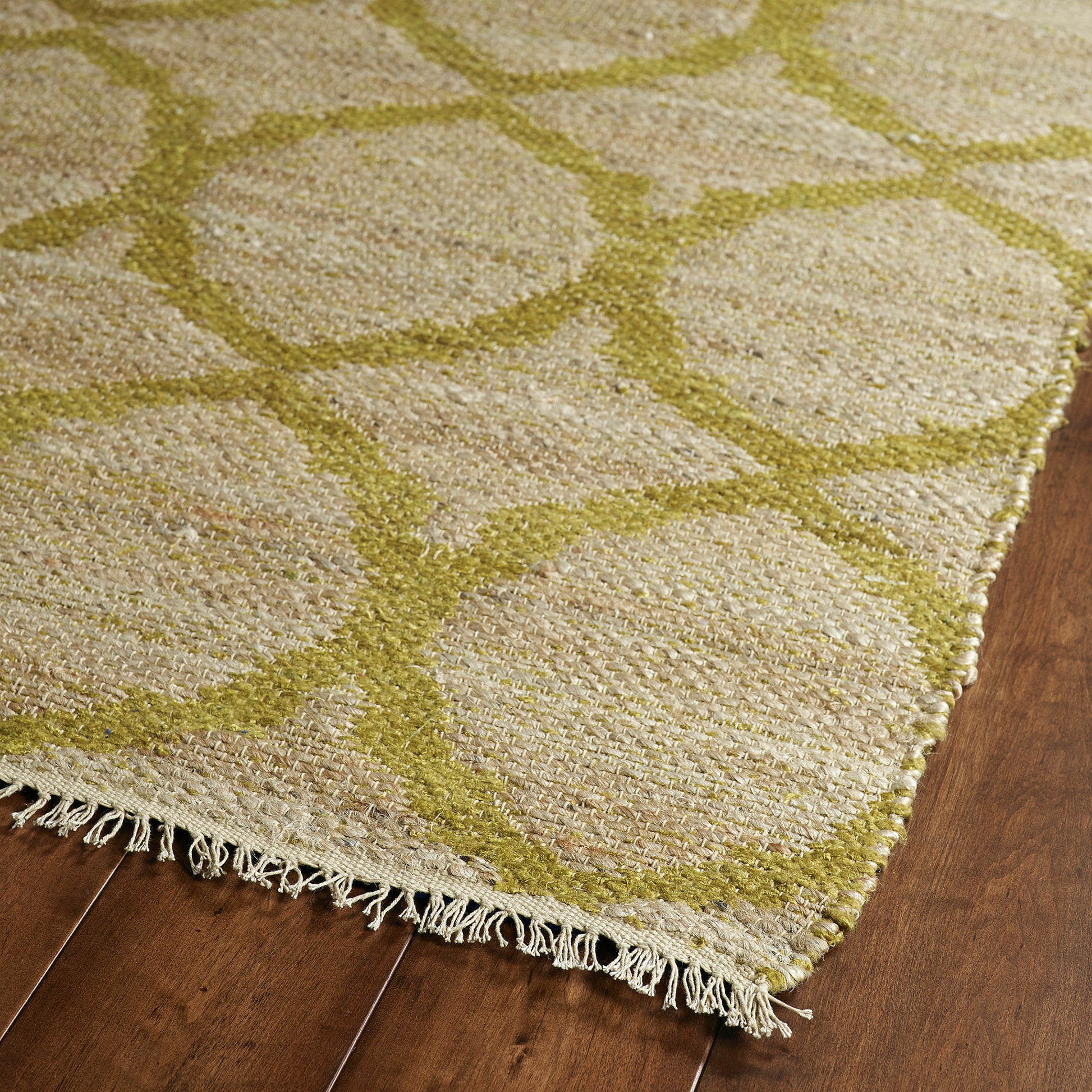Natural fiber rug with a subtle geometric pattern in light green and cream tones