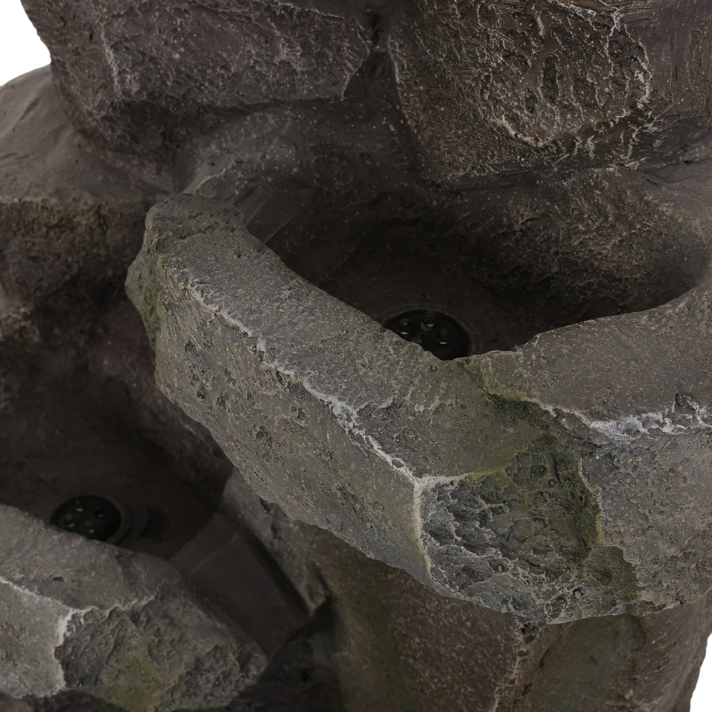 Closeup of a dark grey resin rock feature with mossy accents and builtin lights