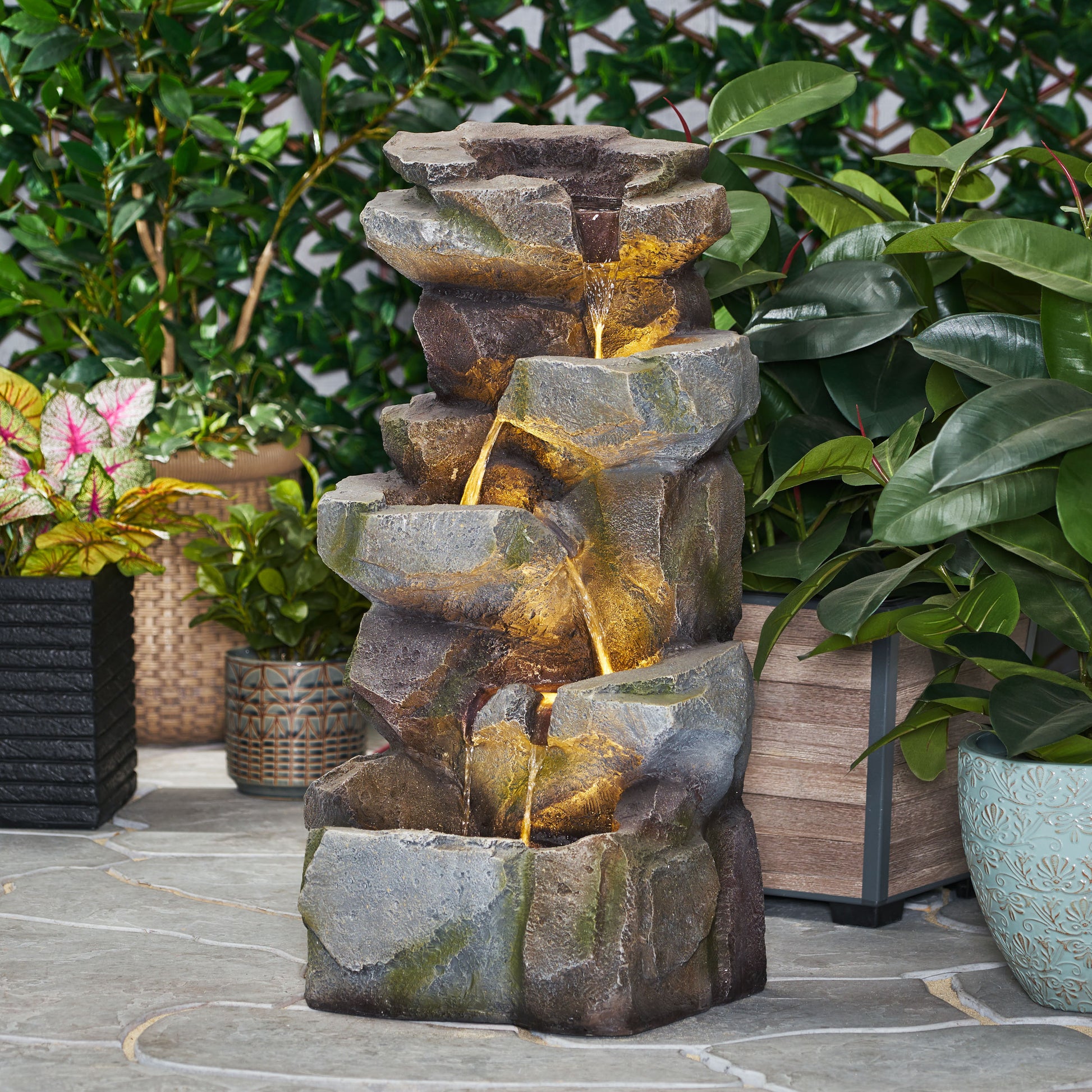 Multitiered rock water feature with integrated LED lighting cascading water effect