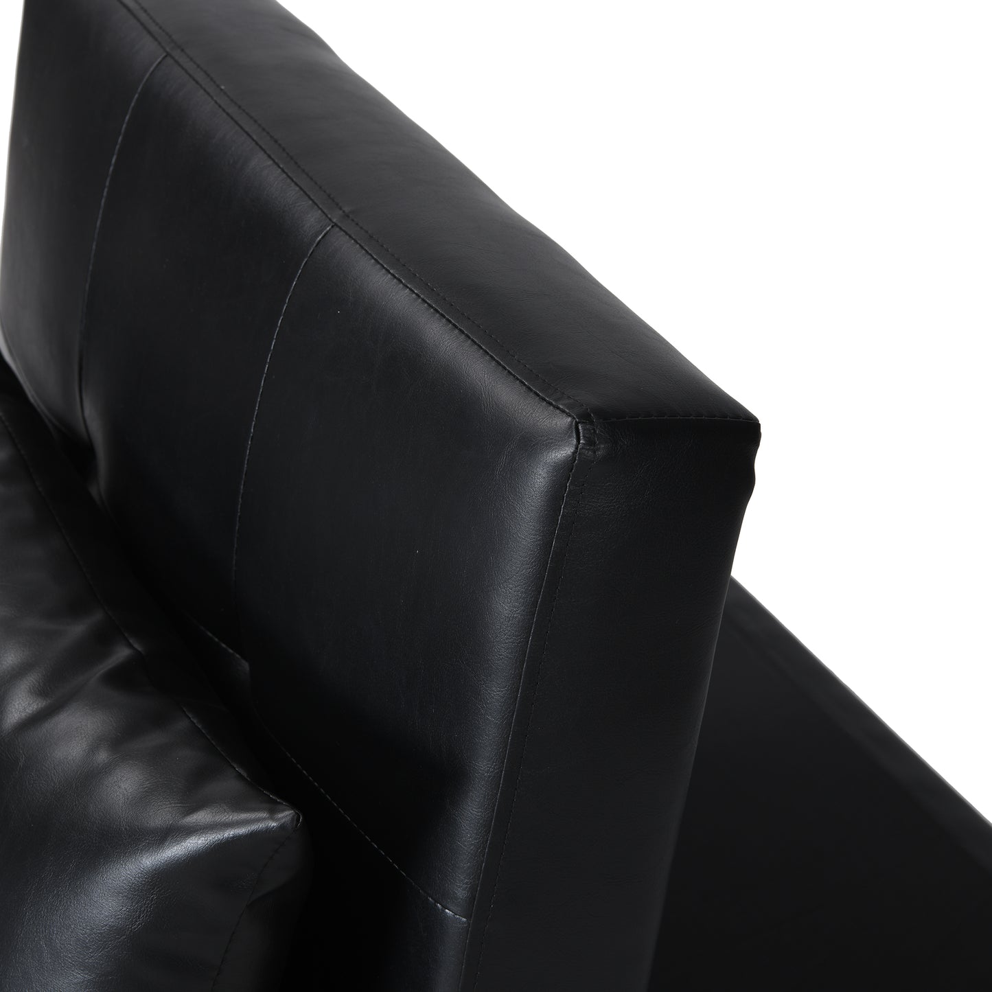Closeup of a black faux leather armchair armrest showing stitched detailing