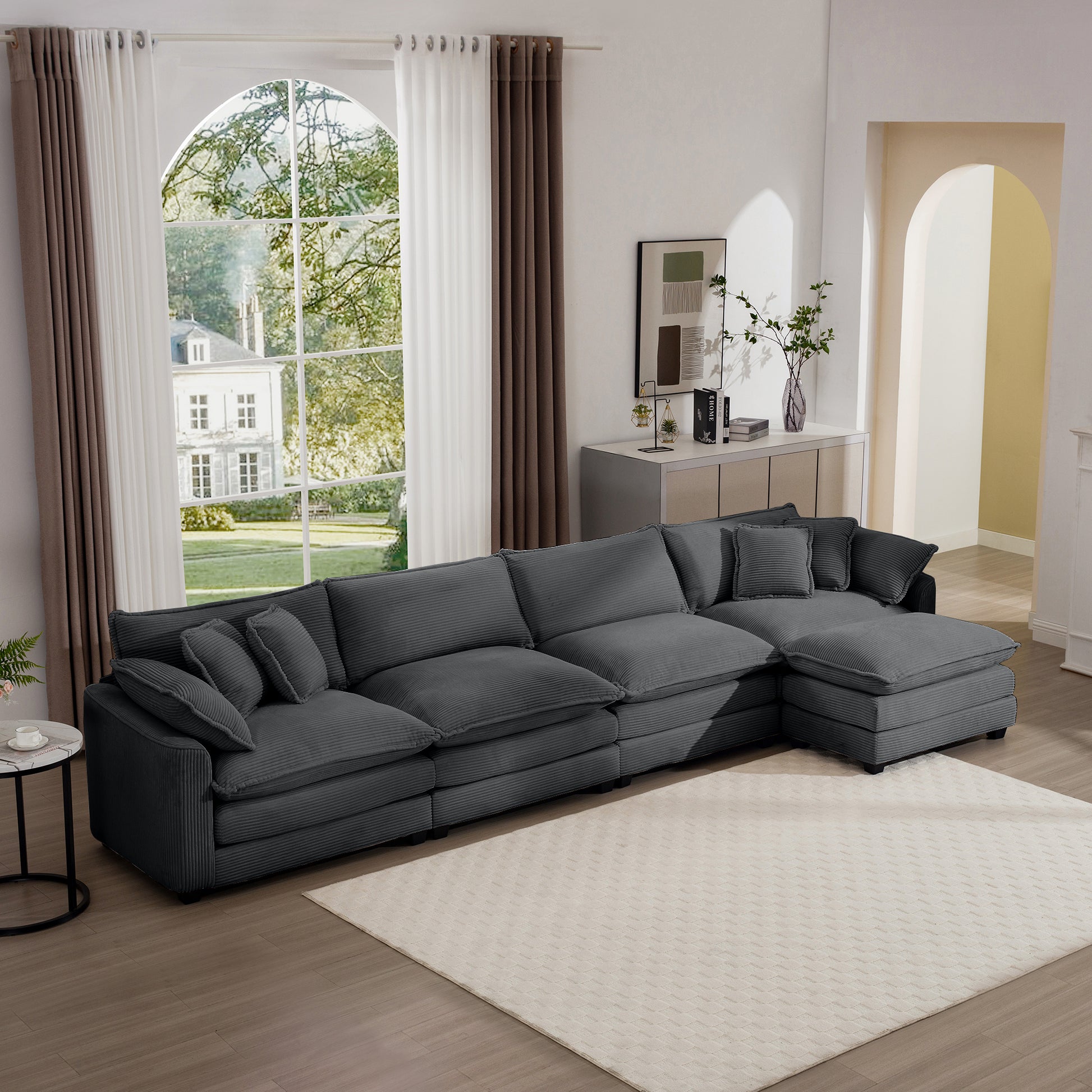 Plush charcoal sectional sofa with textured fabric and multiple throw pillows