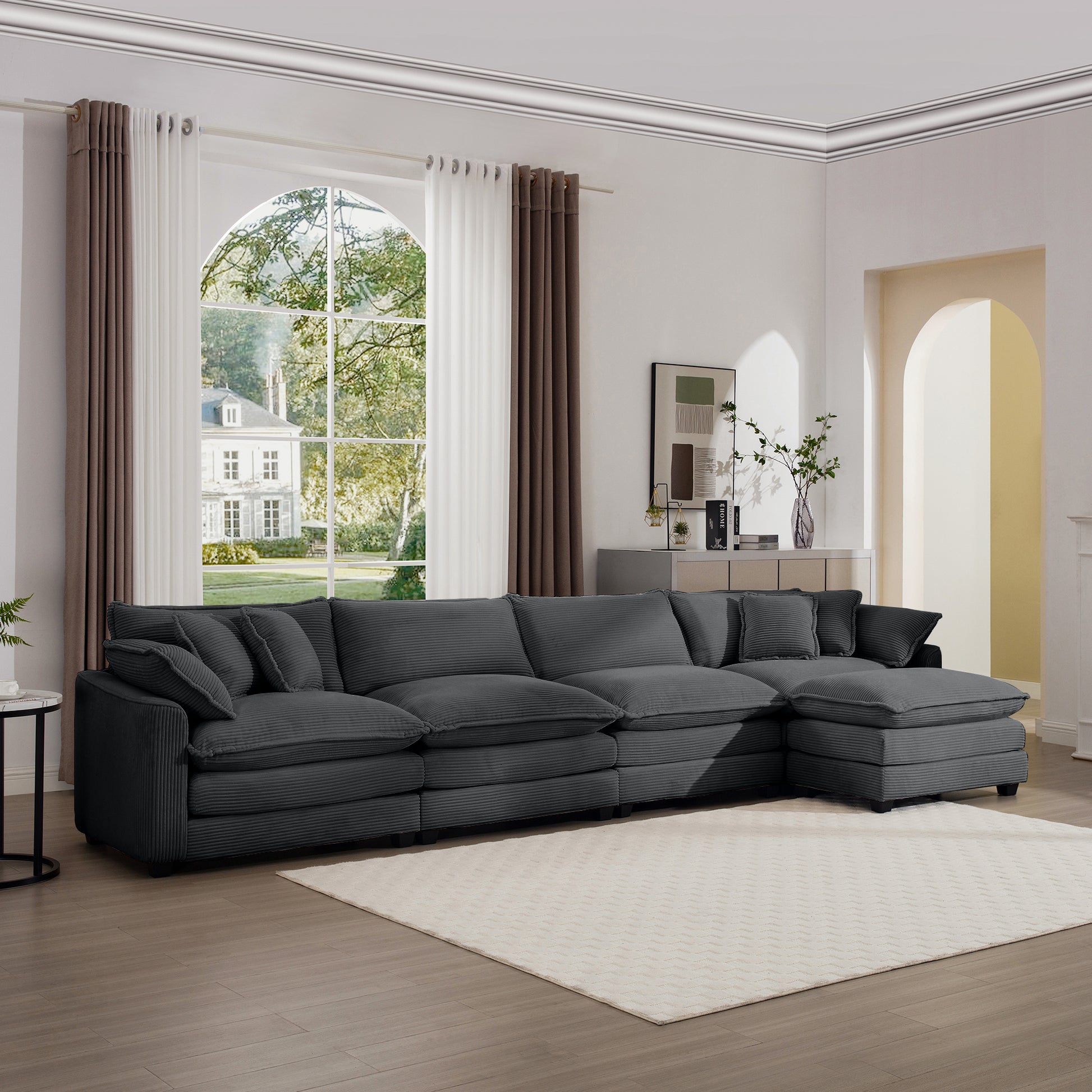 Dark gray corduroy sectional sofa with plush cushions and chaise lounge