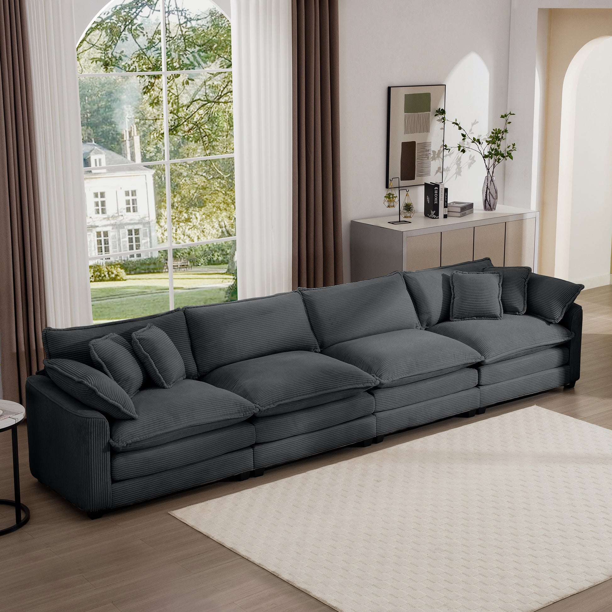 Deep grey corduroy sectional sofa with plush cushions and matching throw pillows