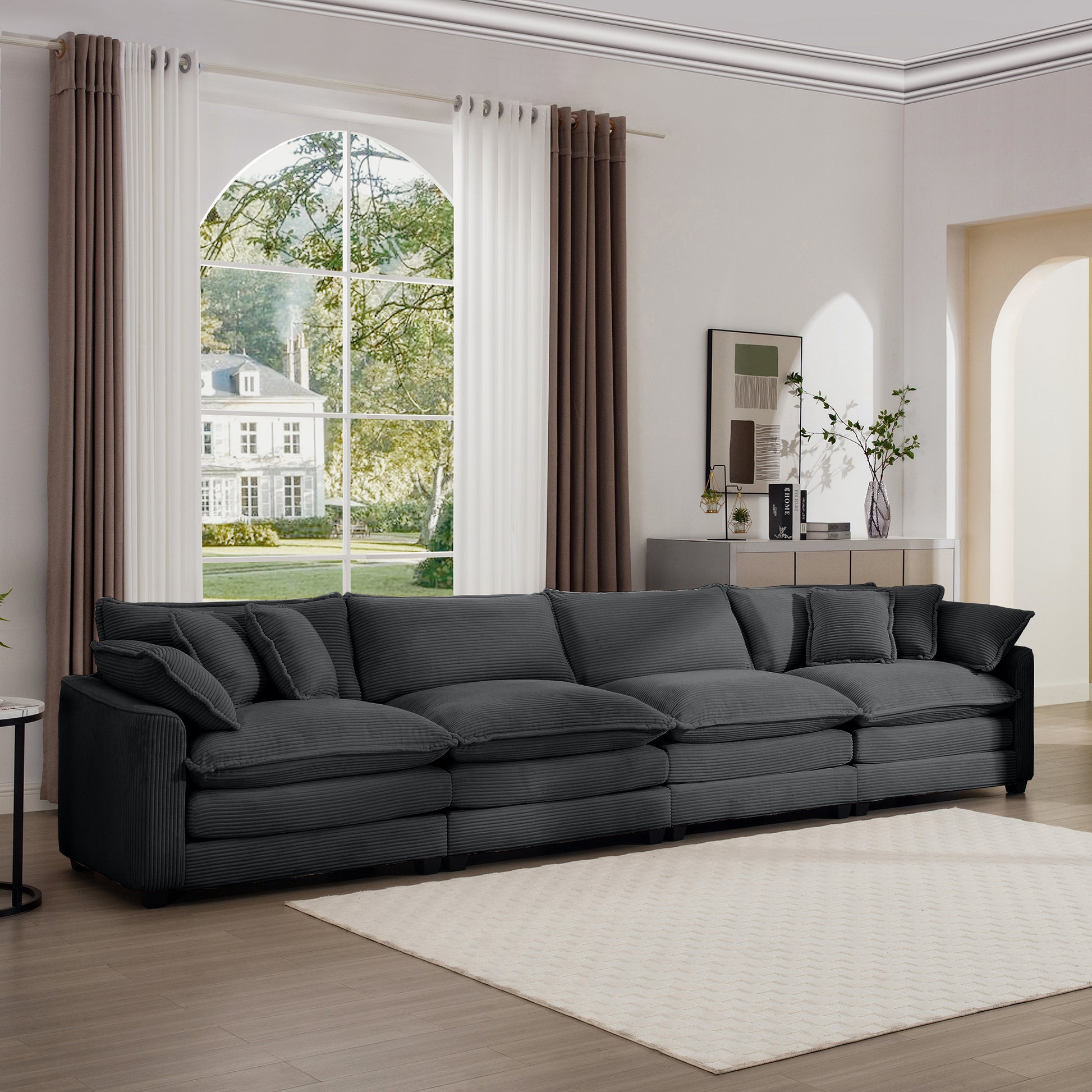 Deep charcoal corduroy sectional sofa with plush oversized cushions and matching throw pillows
