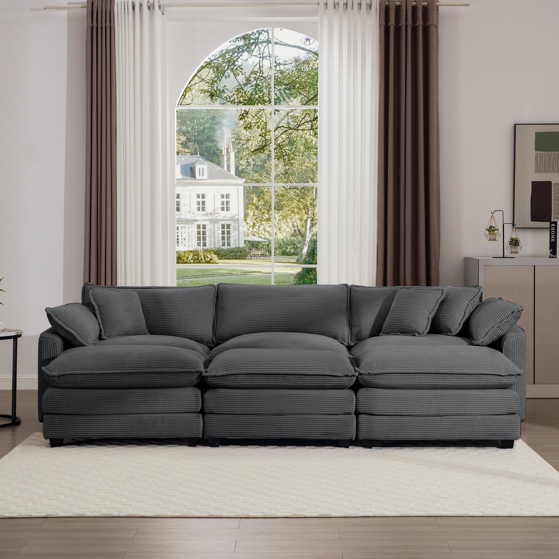 Dark gray corduroy sectional sofa with plush cushions and matching throw pillows