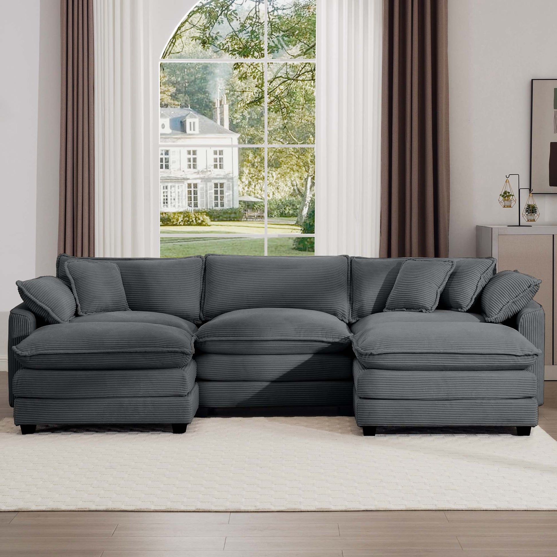 Plush charcoal corduroy sectional sofa with deep seats and multiple throw pillows