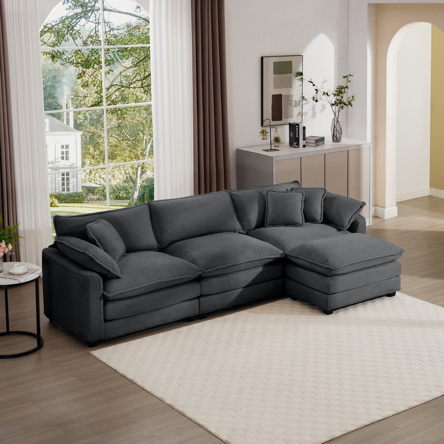 Dark gray corduroy sectional sofa with plush cushions and chaise lounge