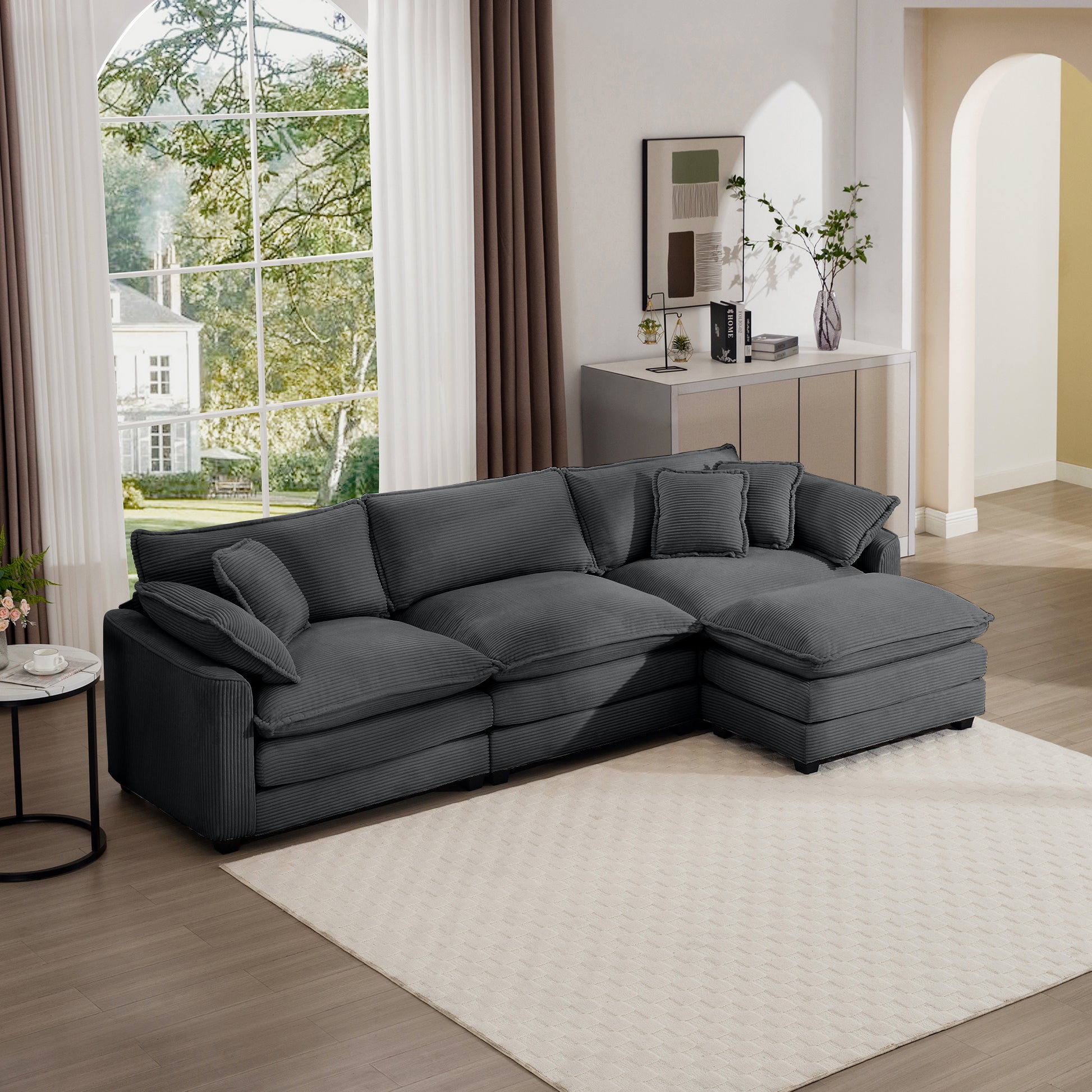 Dark gray corduroy sectional sofa with plush cushions and chaise lounge