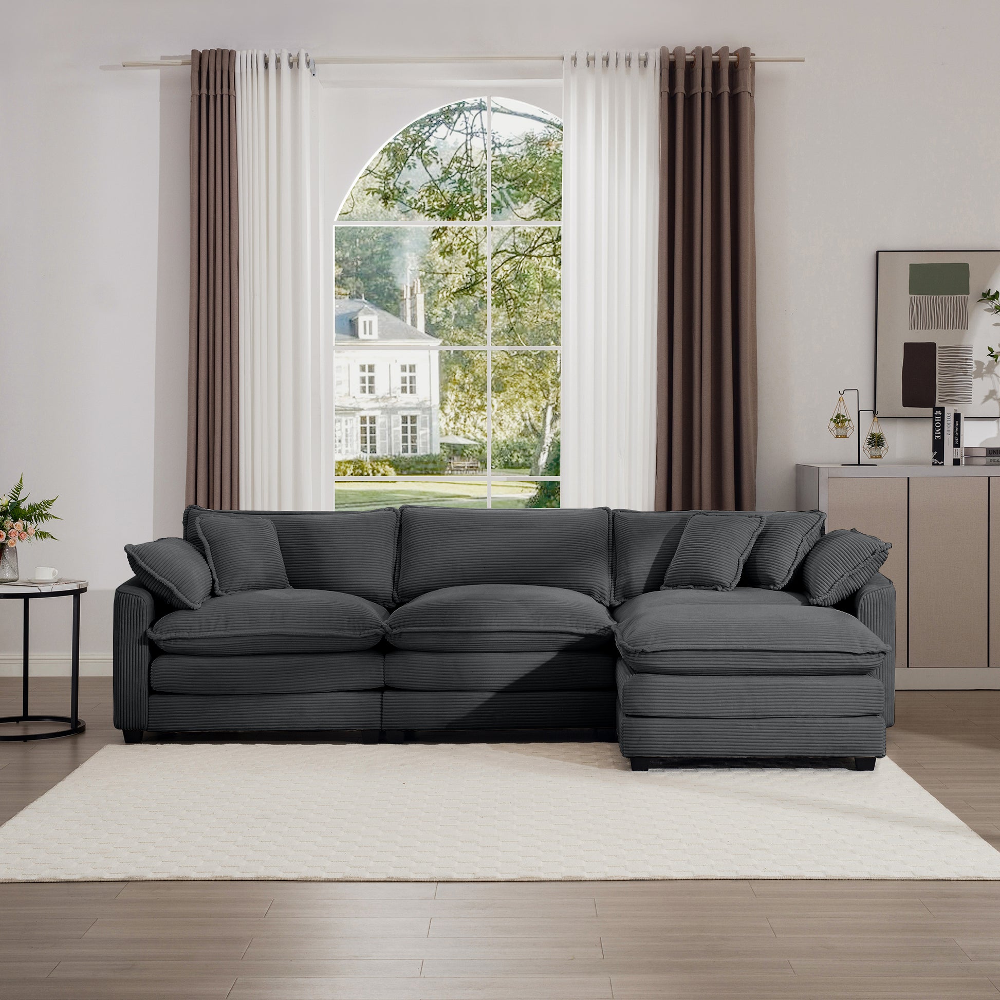 Dark grey corduroy sectional sofa with plush cushions and a chaise lounge