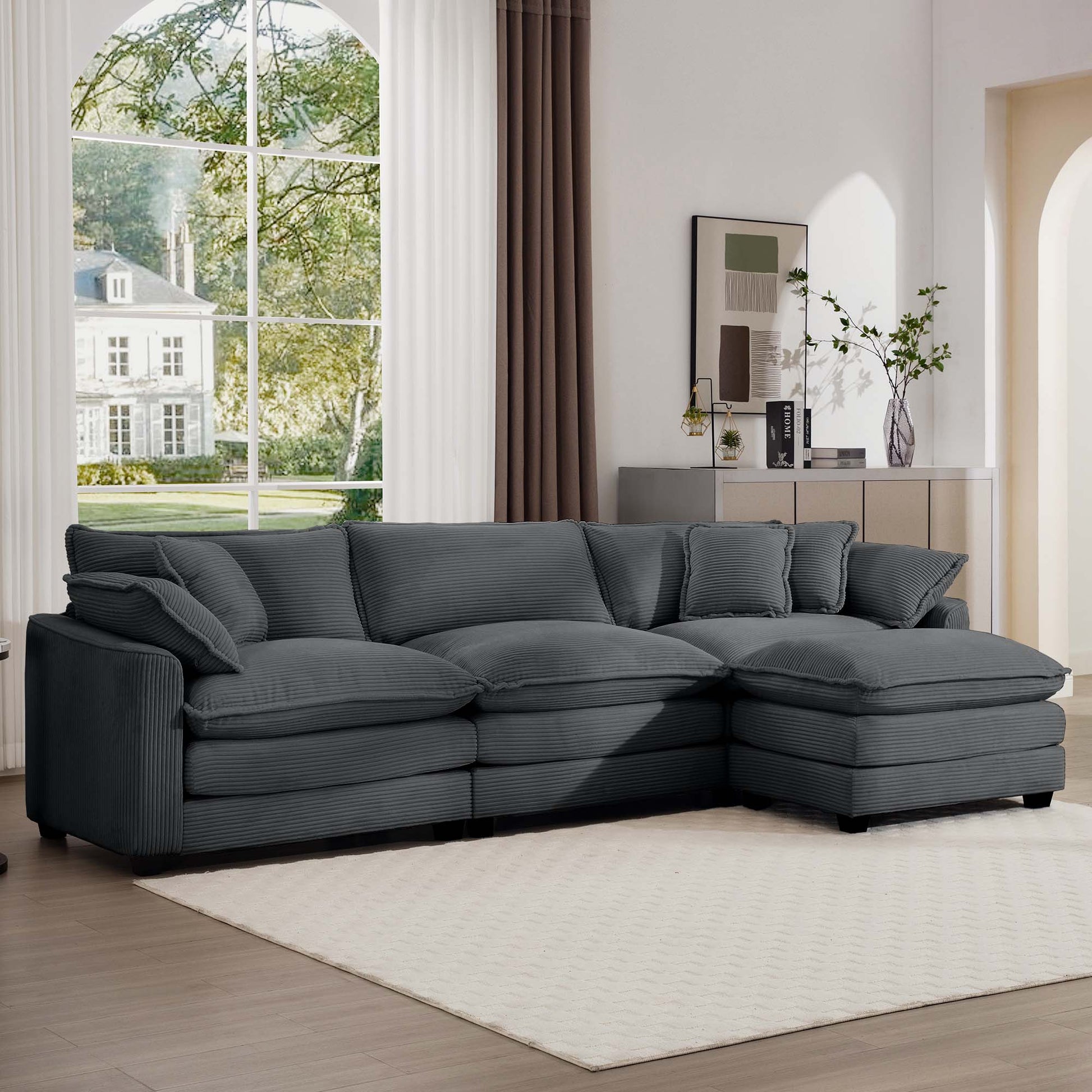 Plush charcoal corduroy sectional sofa with deep seats and multiple throw pillows for ultimate comfort