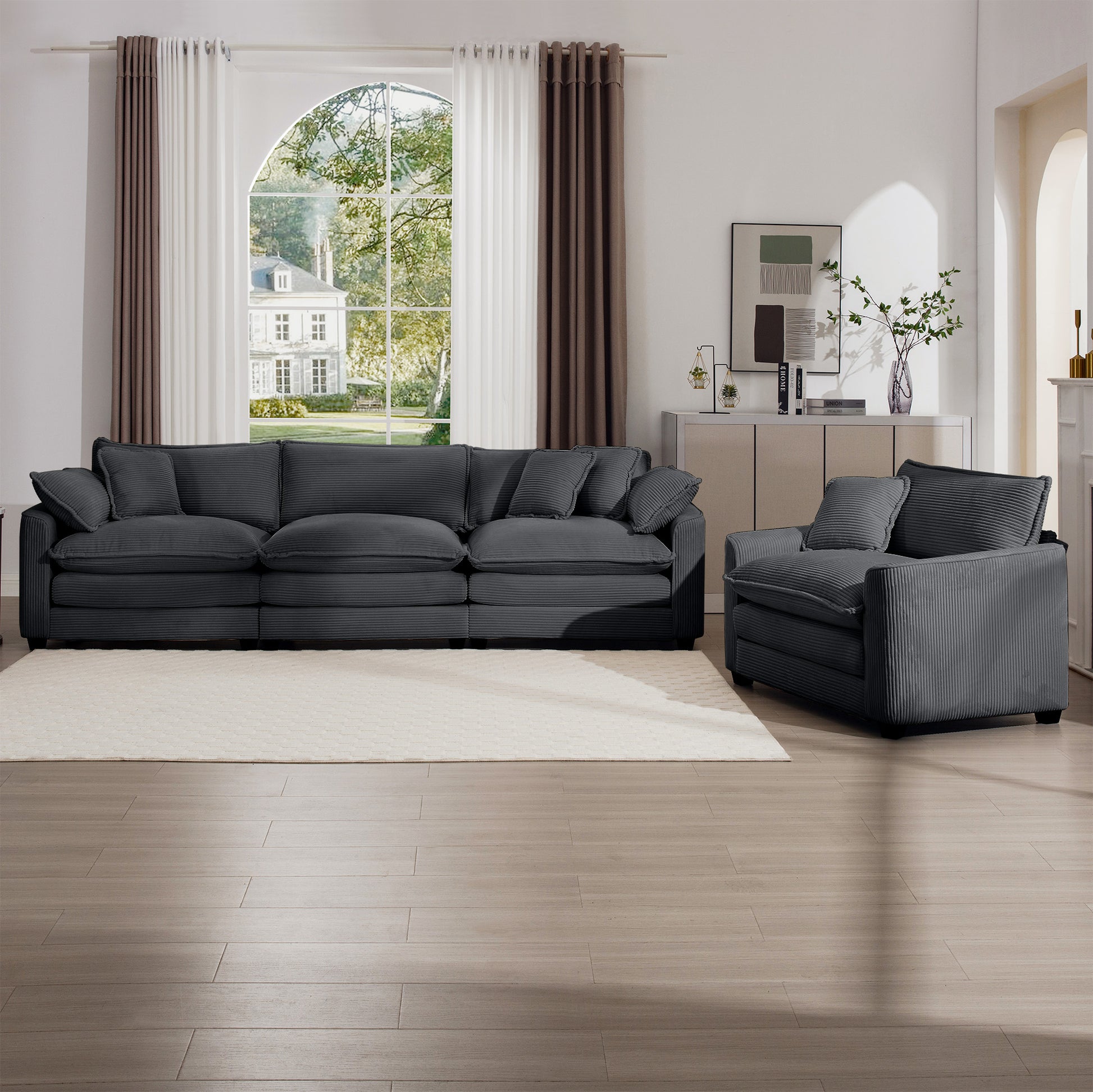 Plush charcoal gray corduroy sofa with deep seats and matching throw pillows