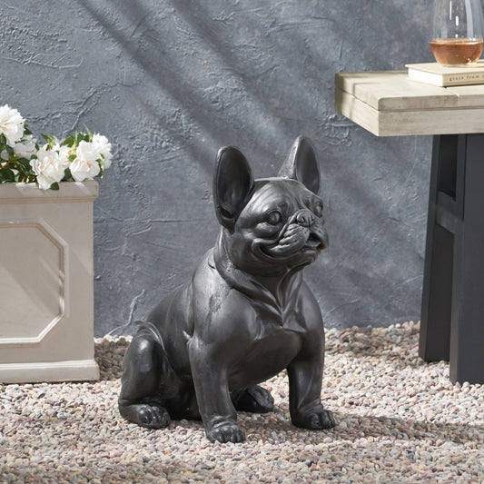 Dark gray French bulldog garden statue sitting on pebbles adding charm to outdoor spaces