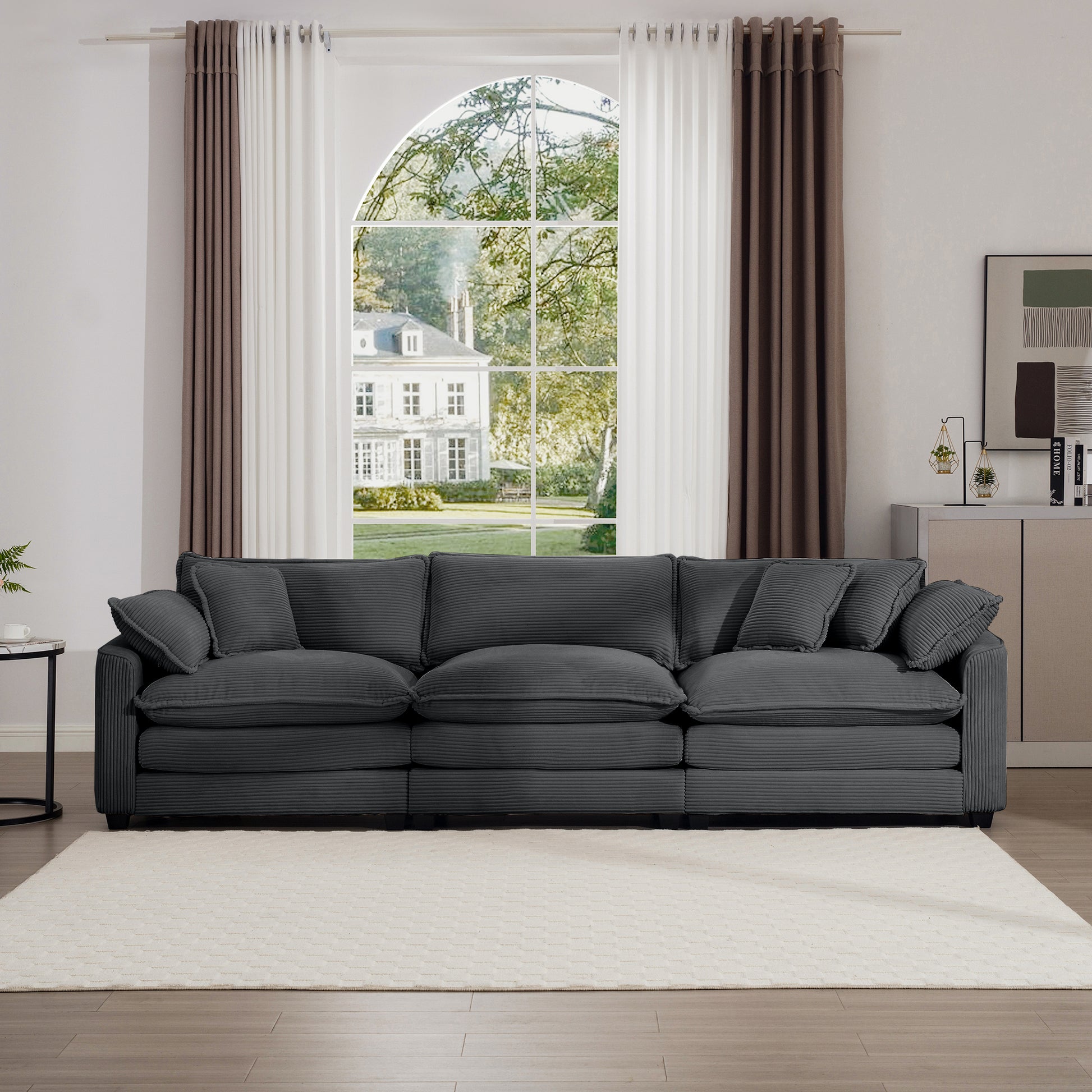 Plush charcoal gray corduroy sofa with plush cushions and matching throw pillows