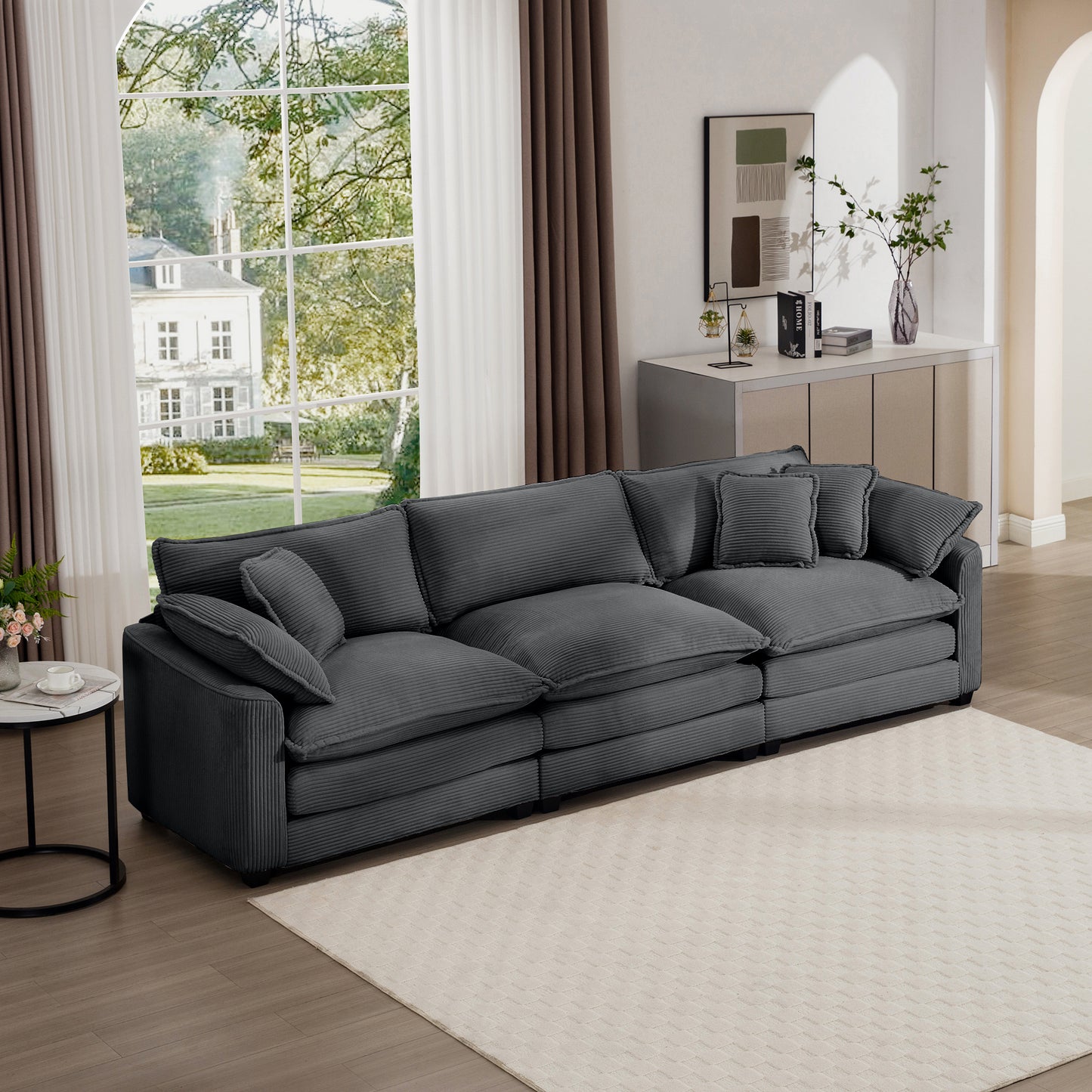Plush dark gray corduroy sectional sofa with deep seats and multiple throw pillows