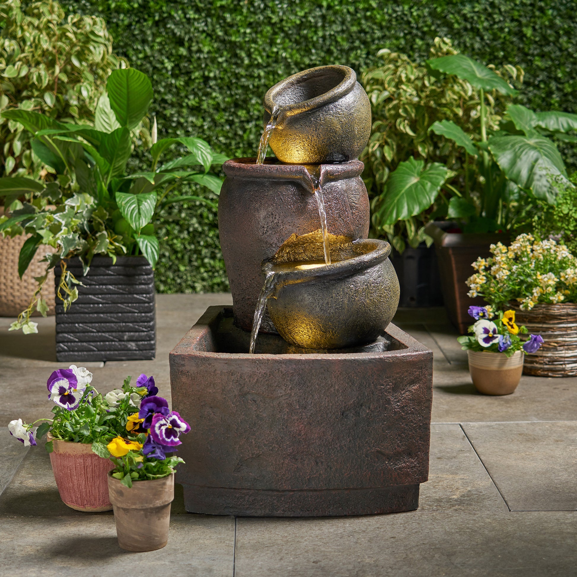 Tiered ceramic garden fountain with cascading water and warm LED lights