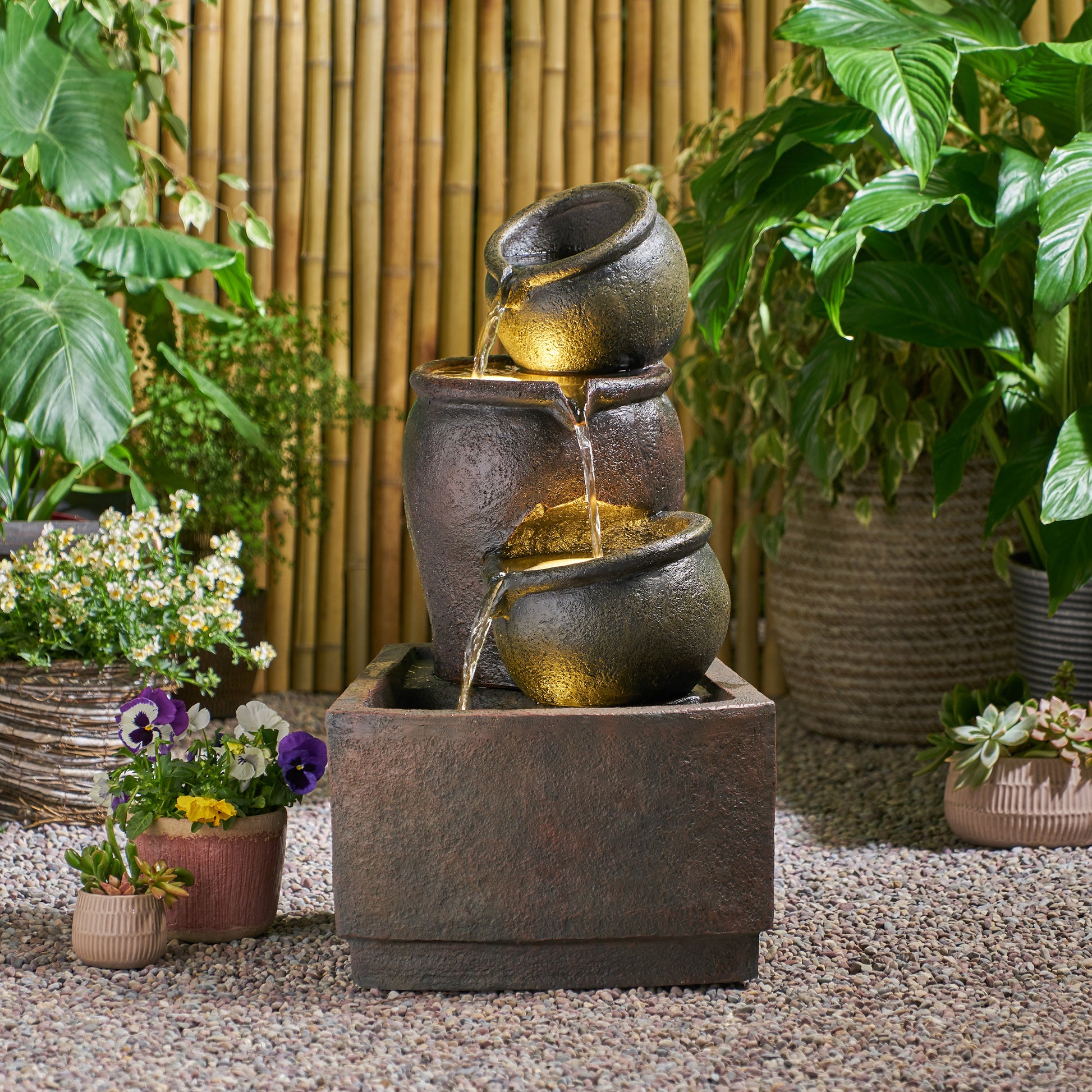 Dark brown tiered pot fountain with cascading water perfect for garden decor