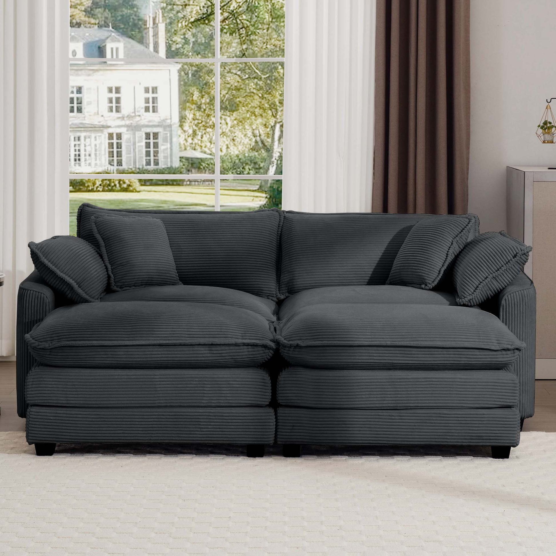 Dark grey corduroy sofa with plush cushions and two throw pillows perfect for modern living rooms