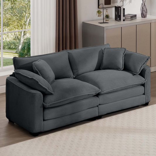 Plush grey corduroy sofa with deep seating and plush cushions perfect for a modern living room