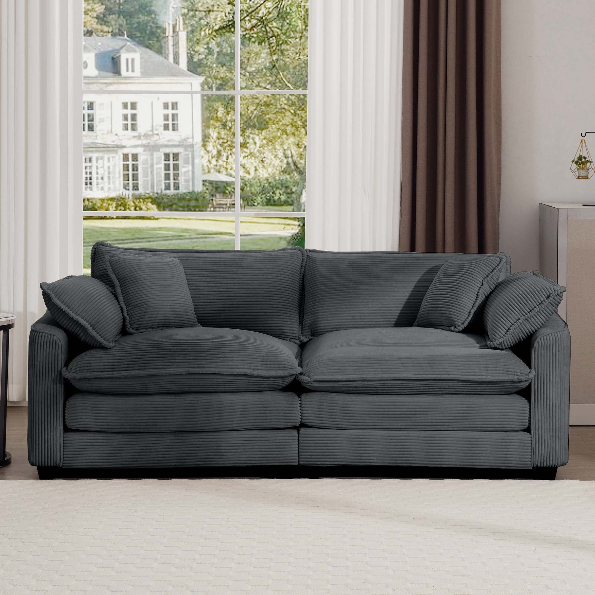 Plush dark grey corduroy sofa with textured cushions and armrests perfect for living rooms
