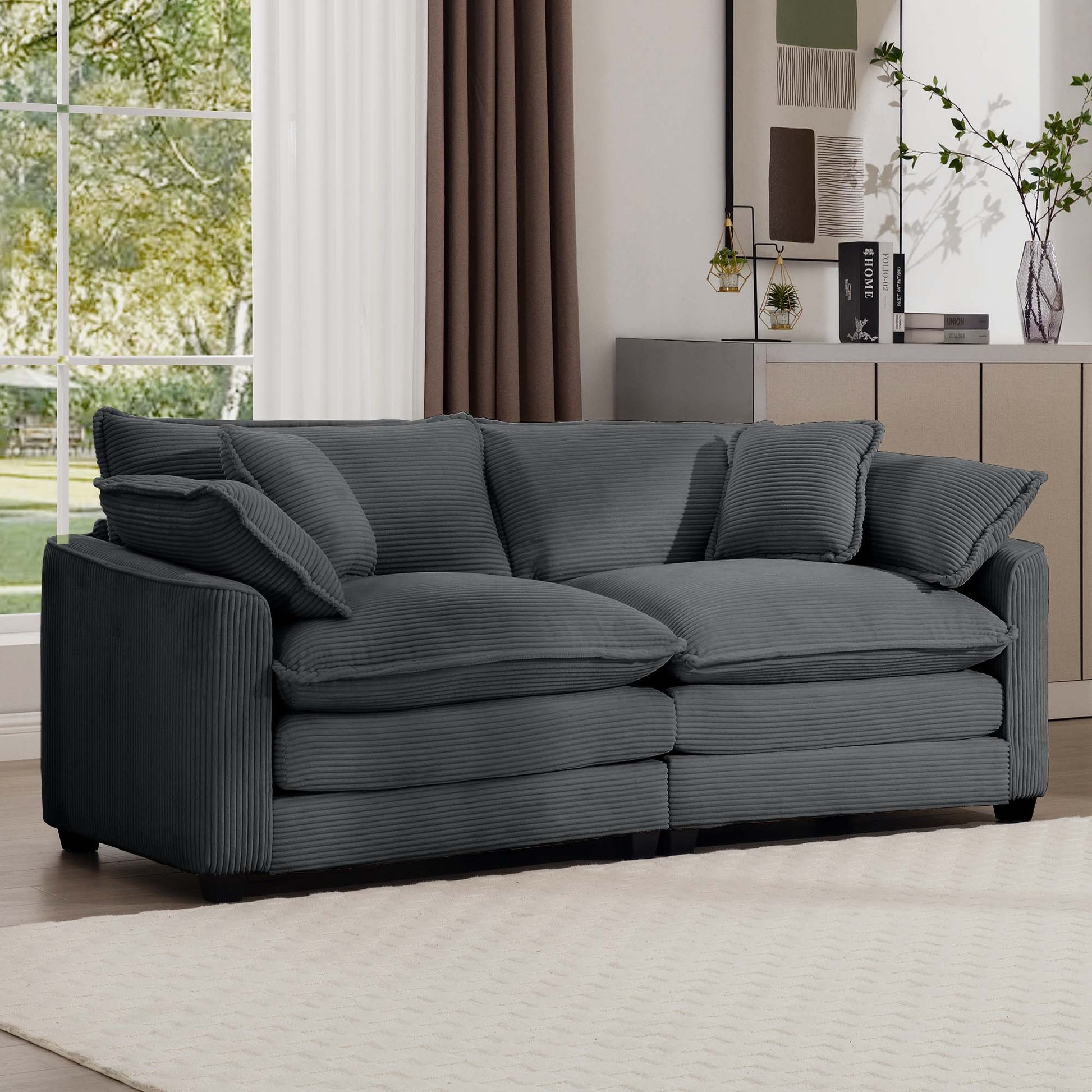 Dark gray corduroy sofa with plush cushions perfect for a cozy living room