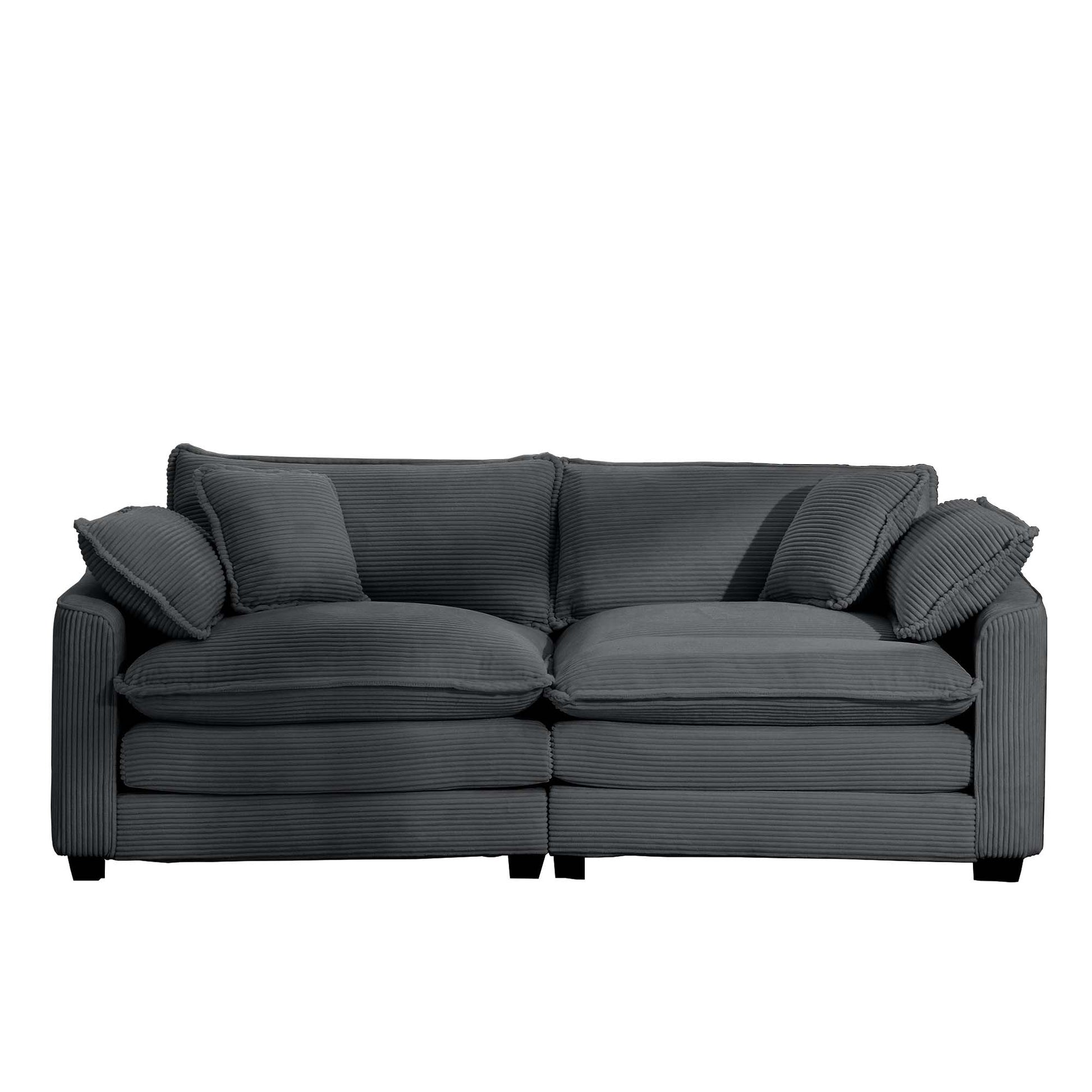Charcoal grey corduroy sofa with plush seat cushions and matching throw pillows