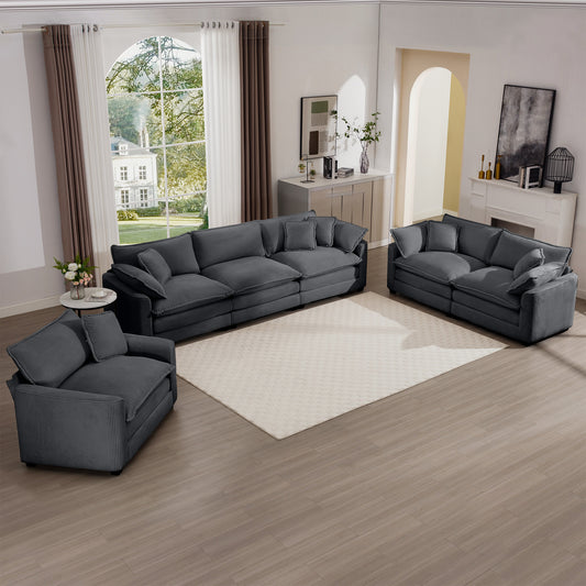 Dark gray corduroy sectional sofa with plush cushions and throw pillows perfect for a modern living room