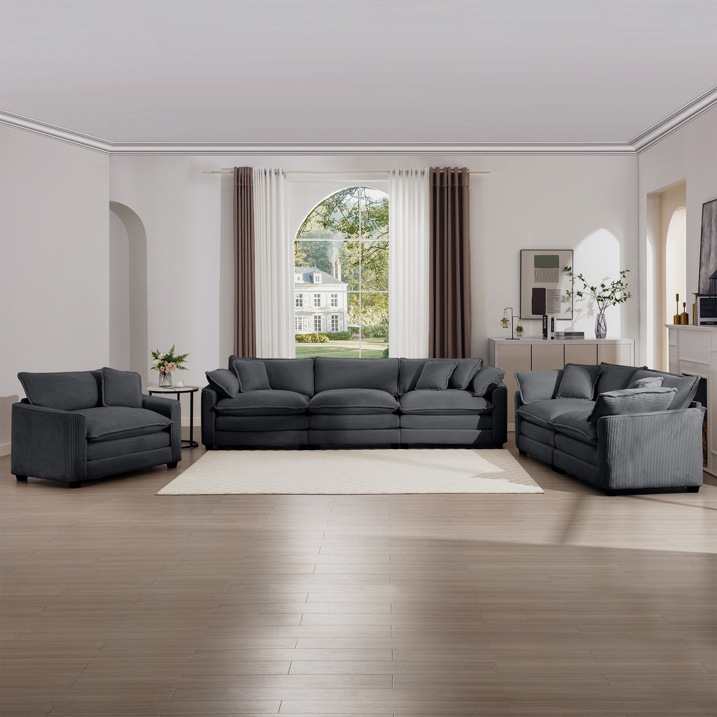 Dark gray corduroy sectional sofa with plush cushions and matching armchair
