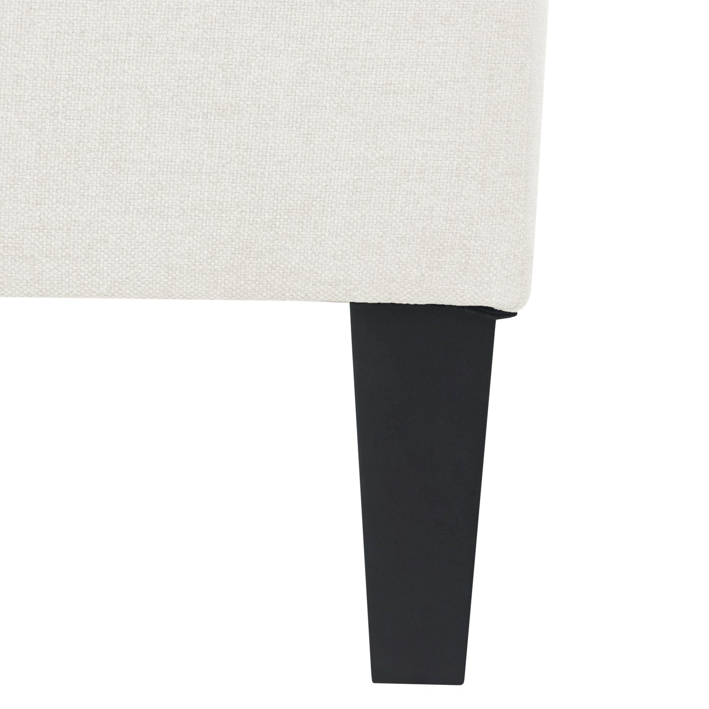 Closeup of textured offwhite fabric on a modern sofa leg in black