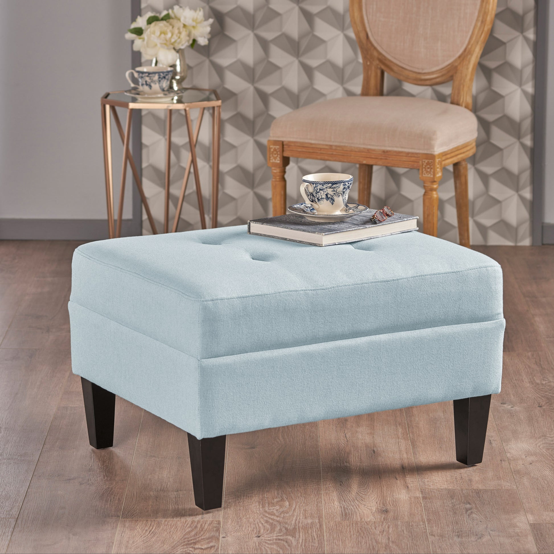 Light blue tufted fabric ottoman with dark wooden legs perfect accent for any living room